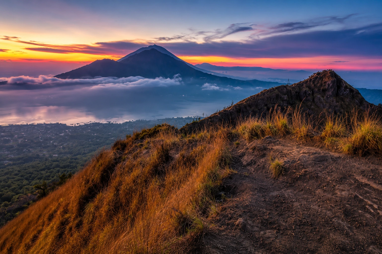 Mount Batur sunrise trekking view across the Kintamani caldera.