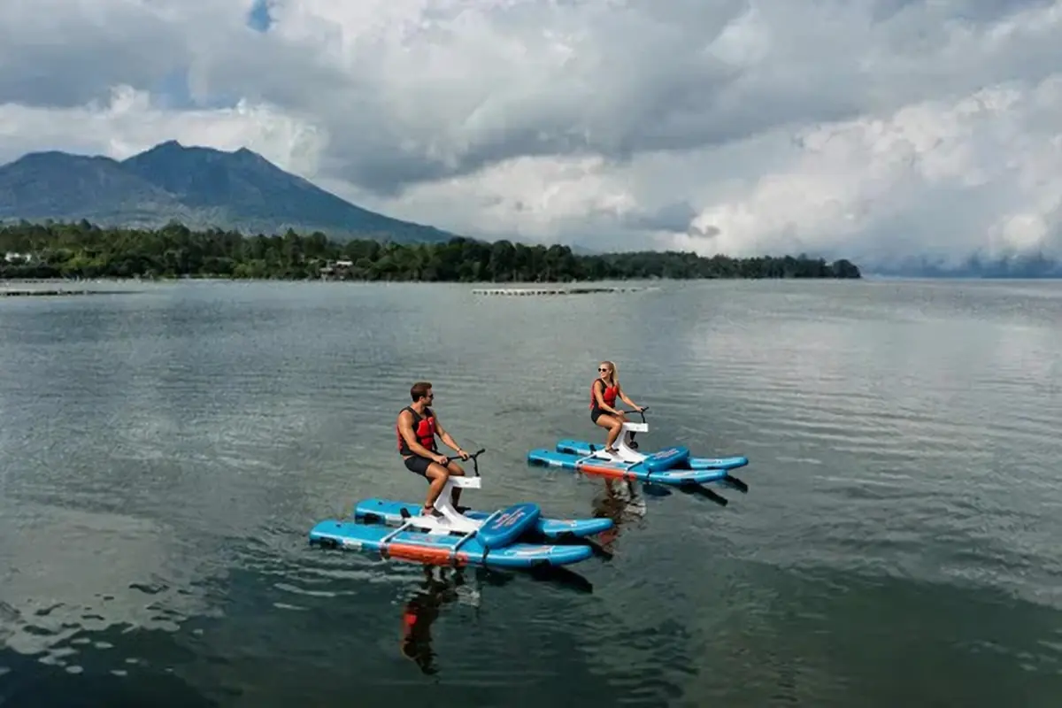 Two people each using a separate single-person waterbike on Lake Batur.