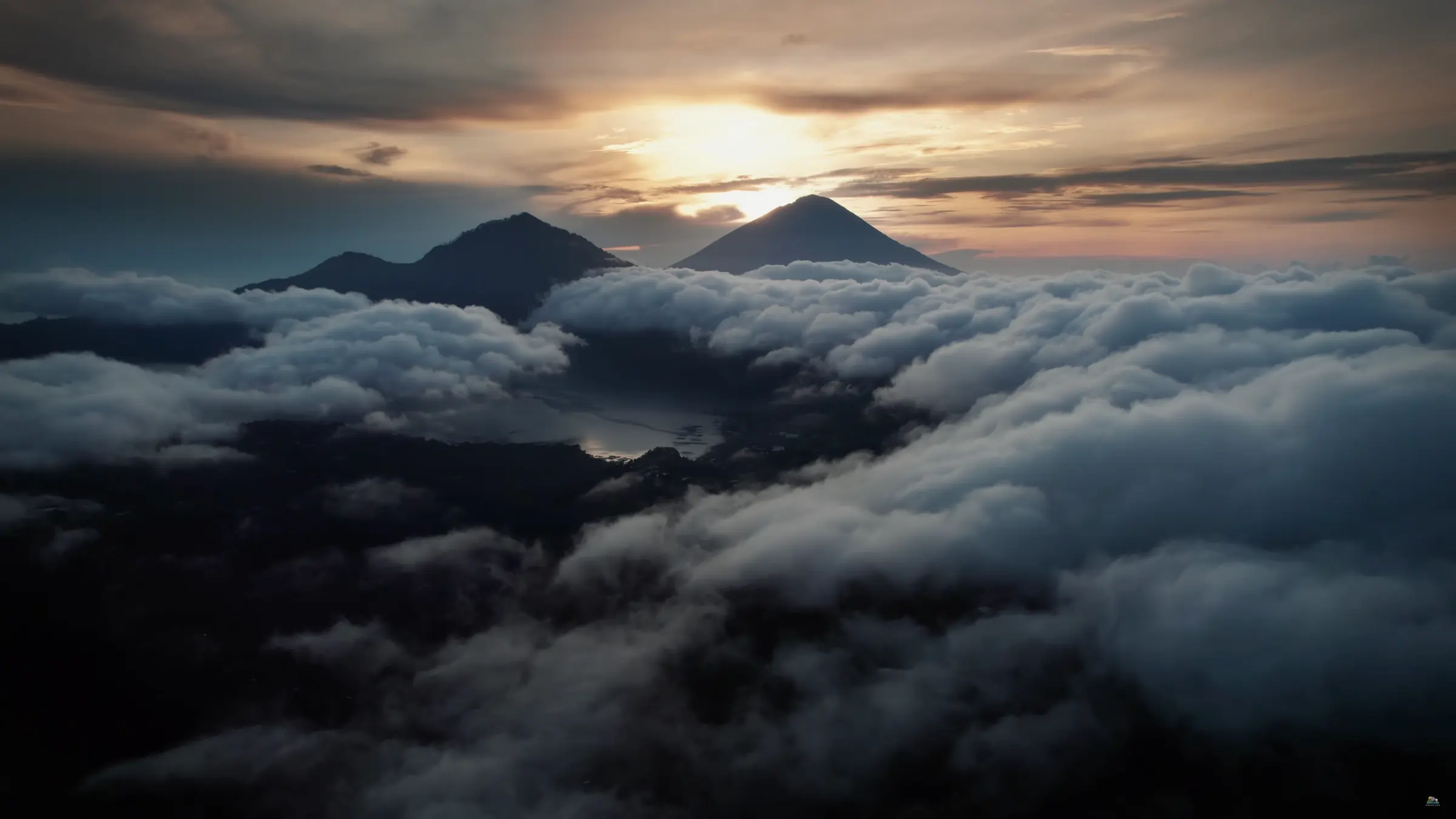 Arkaluna above the clouds in Kintamani with sunrise light across the highland landscape.