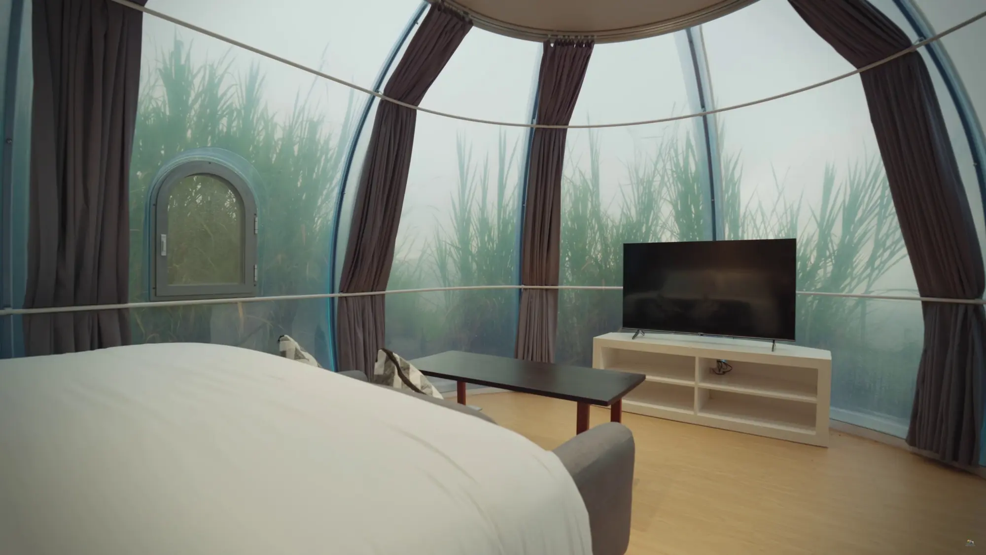 Crystal Nest Suites in-room lounge with sofa, 50-inch TV, and mountain view in Kintamani.